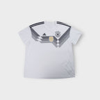 White Adidas DFB 2018 jersey with black geometric chest graphic and gold FIFA badge.