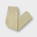 Tommy Hilfiger beige trousers featuring an embroidered flag patch on the back pocket