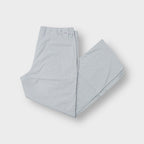 Grey Lacoste pinstripe trousers featuring an embroidered crocodile logo on the back waist tab