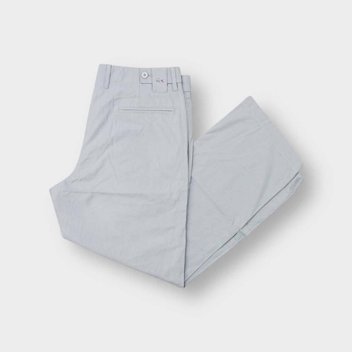 Grey Lacoste pinstripe trousers featuring an embroidered crocodile logo on the back waist tab