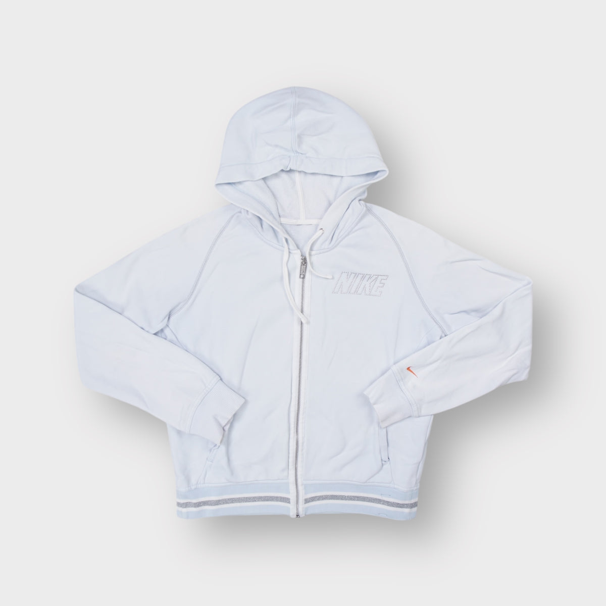 Nike full-zip hoodie in light blue with silver studded chest logo and striped trim