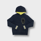 Black Nike hoodie with yellow lined hood and a large chest patch logo