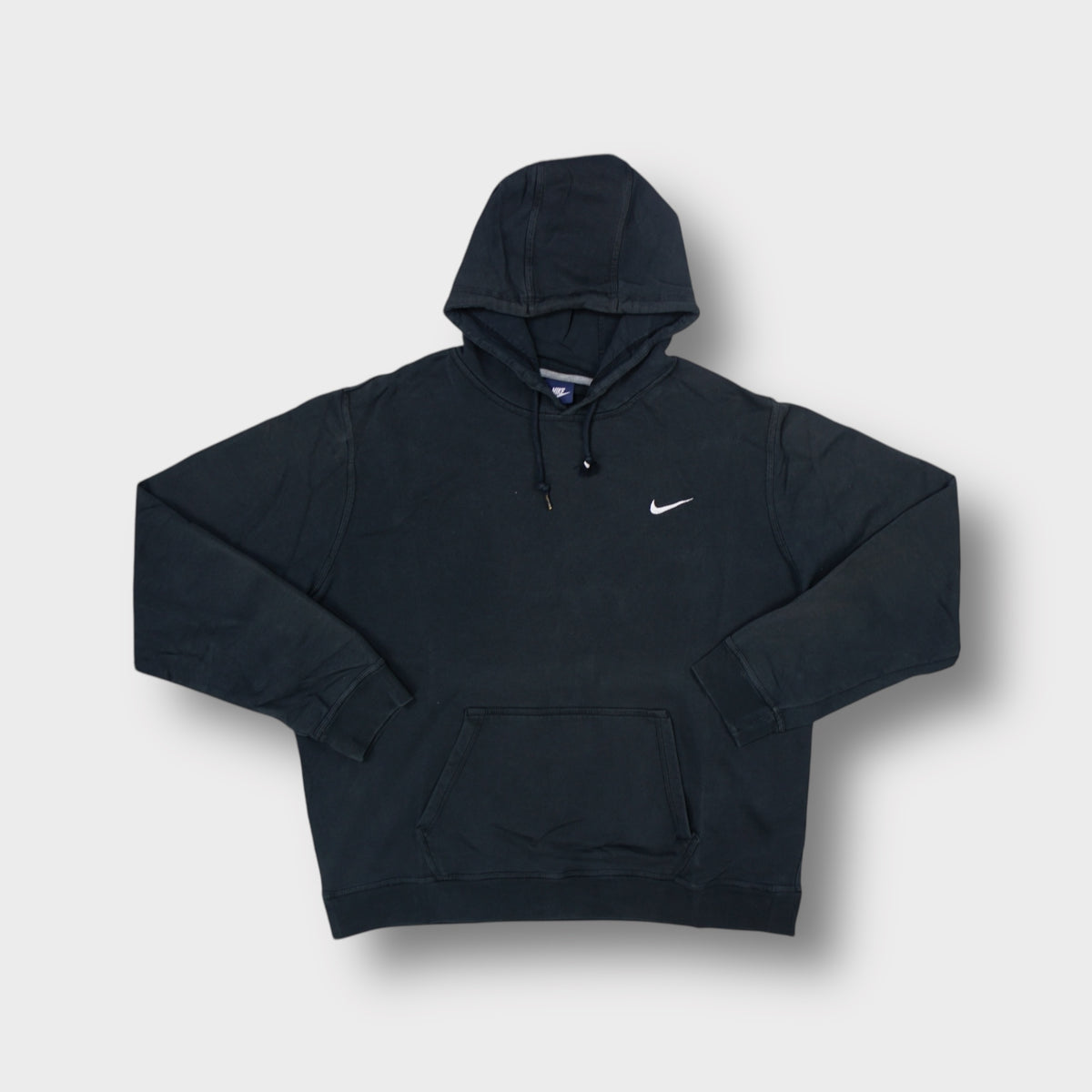 Black Nike hoodie with small white embroidered Swoosh logo on left chest