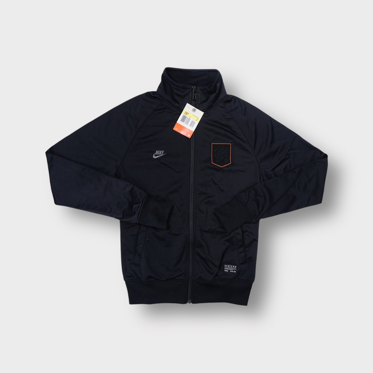 Nike black track jacket with an embroidered Dutch KNVB crest and orange border