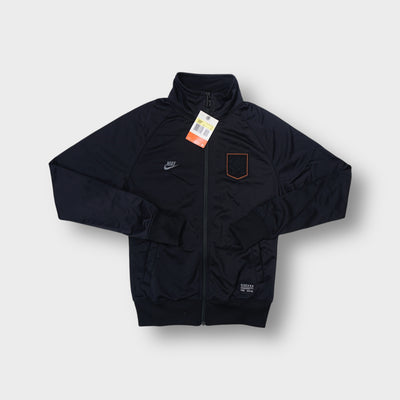 Nike black track jacket with an embroidered Dutch KNVB crest and orange border