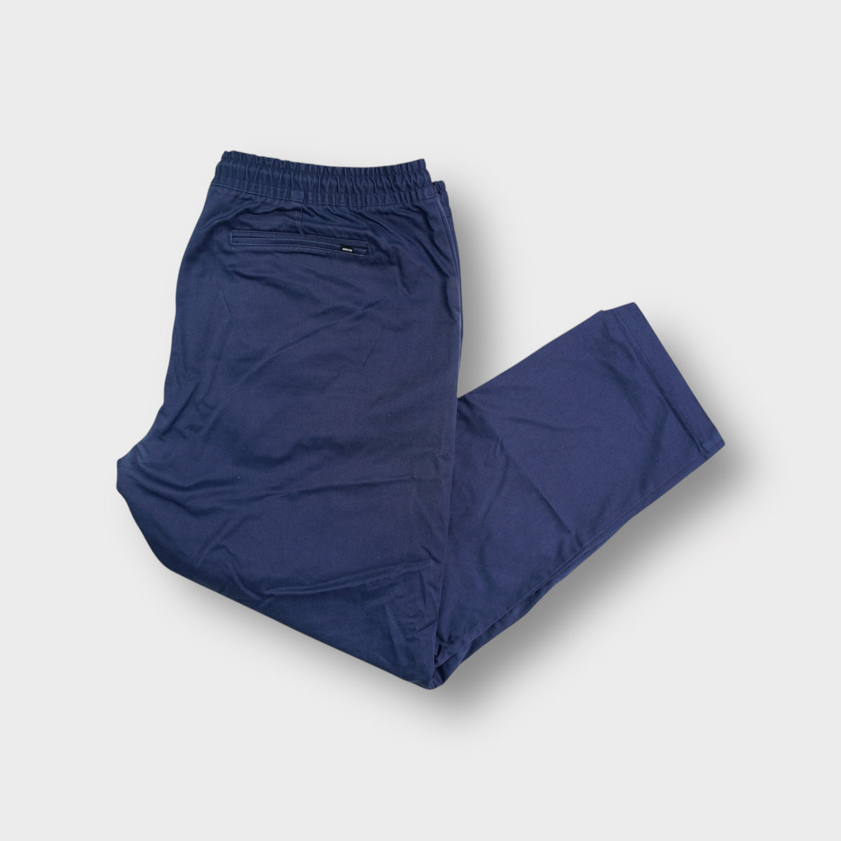 Blue Nike SB trousers featuring an elasticated waistband and straight leg cut
