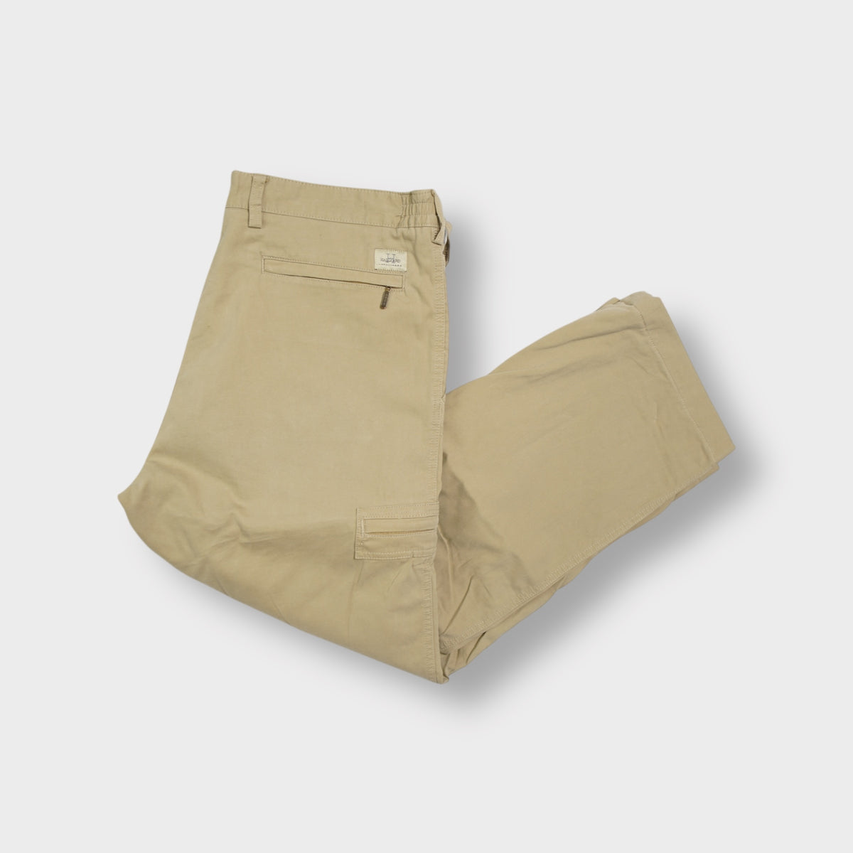 Beige Hallyard trousers with side cargo zip pockets and small brand patch