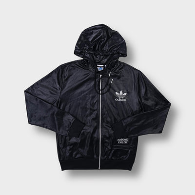 Adidas shiny black Chile 62 track jacket featuring an embroidered trefoil logo