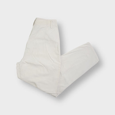 Beige Jinglers trousers with high waist, front pleats, and small side pocket tab.