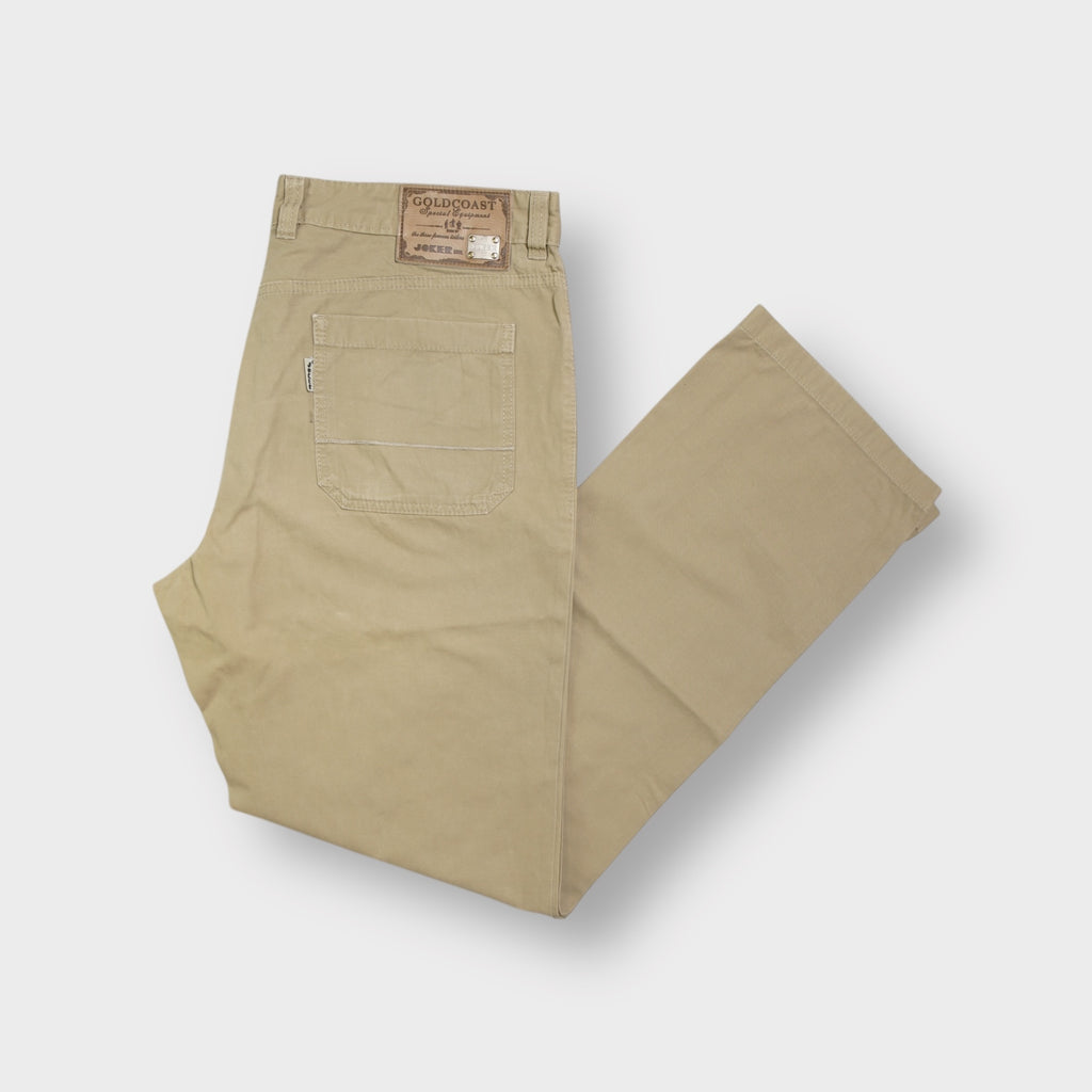 Joker beige pants featuring a back waistband leather patch with metal logo detail.