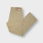 Joker beige pants featuring a back waistband leather patch with metal logo detail.