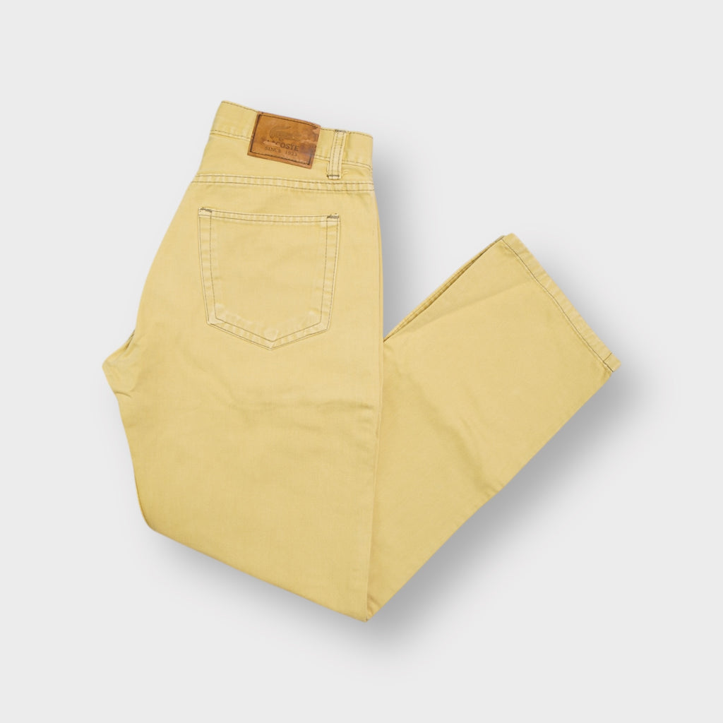 Lacoste yellow jeans with a leather logo waist patch and small pocket side tab