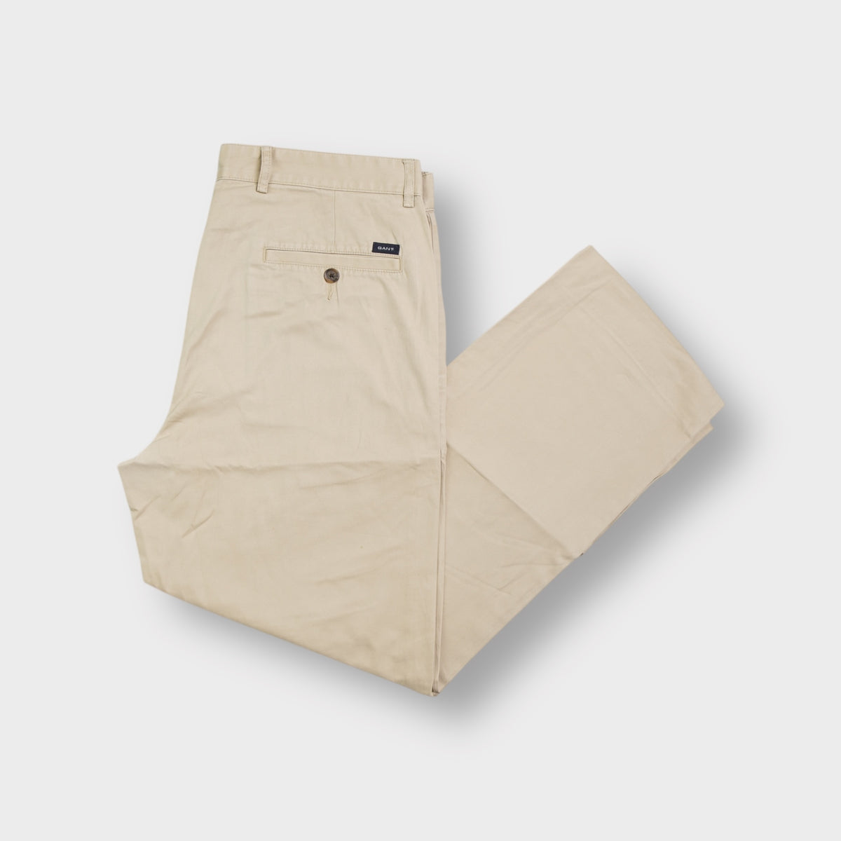 Gant beige chino trousers showing back welt pocket with a small woven brand label