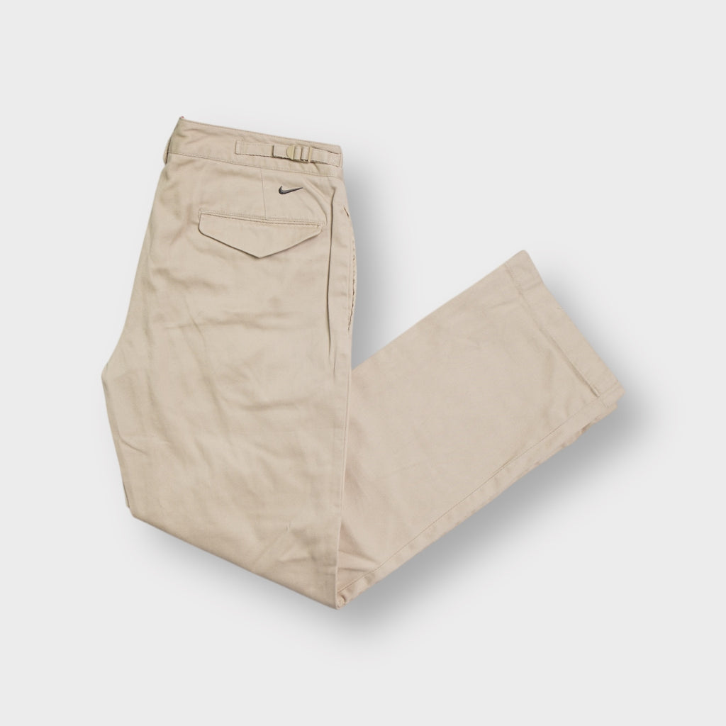 Nike beige trousers with small embroidered swoosh logo above rear pocket