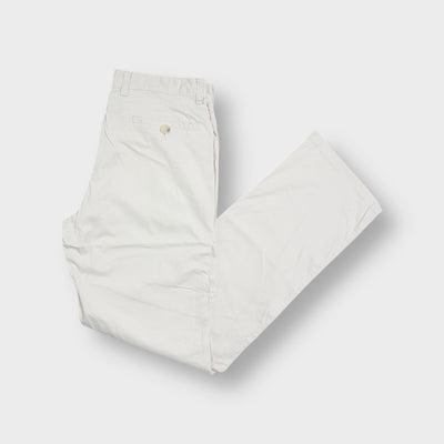 Beige Burberry trousers with embroidered back pocket logo details.