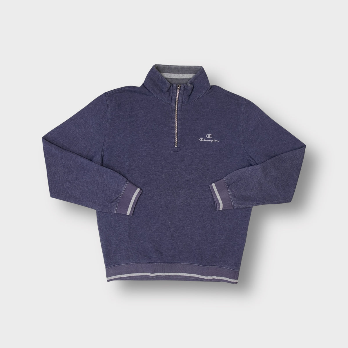 Champion blue sweater half-zip collar with small embroidered chest logo and striped cuffs