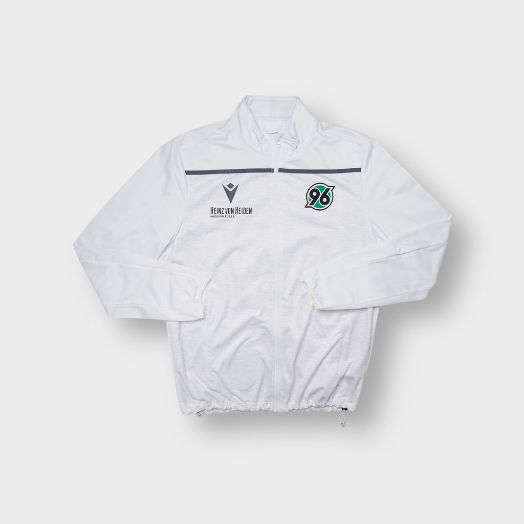 Macron Hannover 96 track jacket in white with green crest and black sponsor print