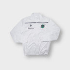 Macron Hannover 96 track jacket in white with green crest and black sponsor print