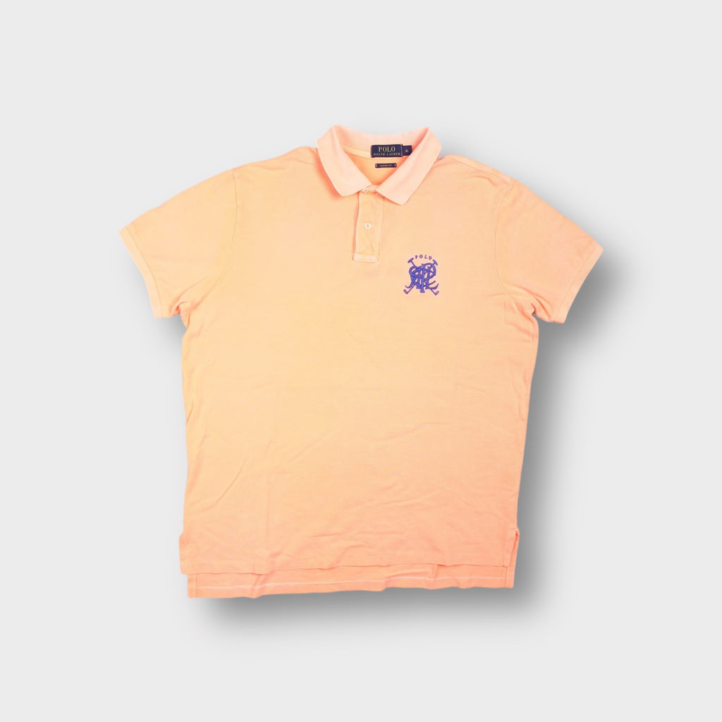 Ralph Lauren polo shirt in orange with a purple embroidered monogram crest on the chest