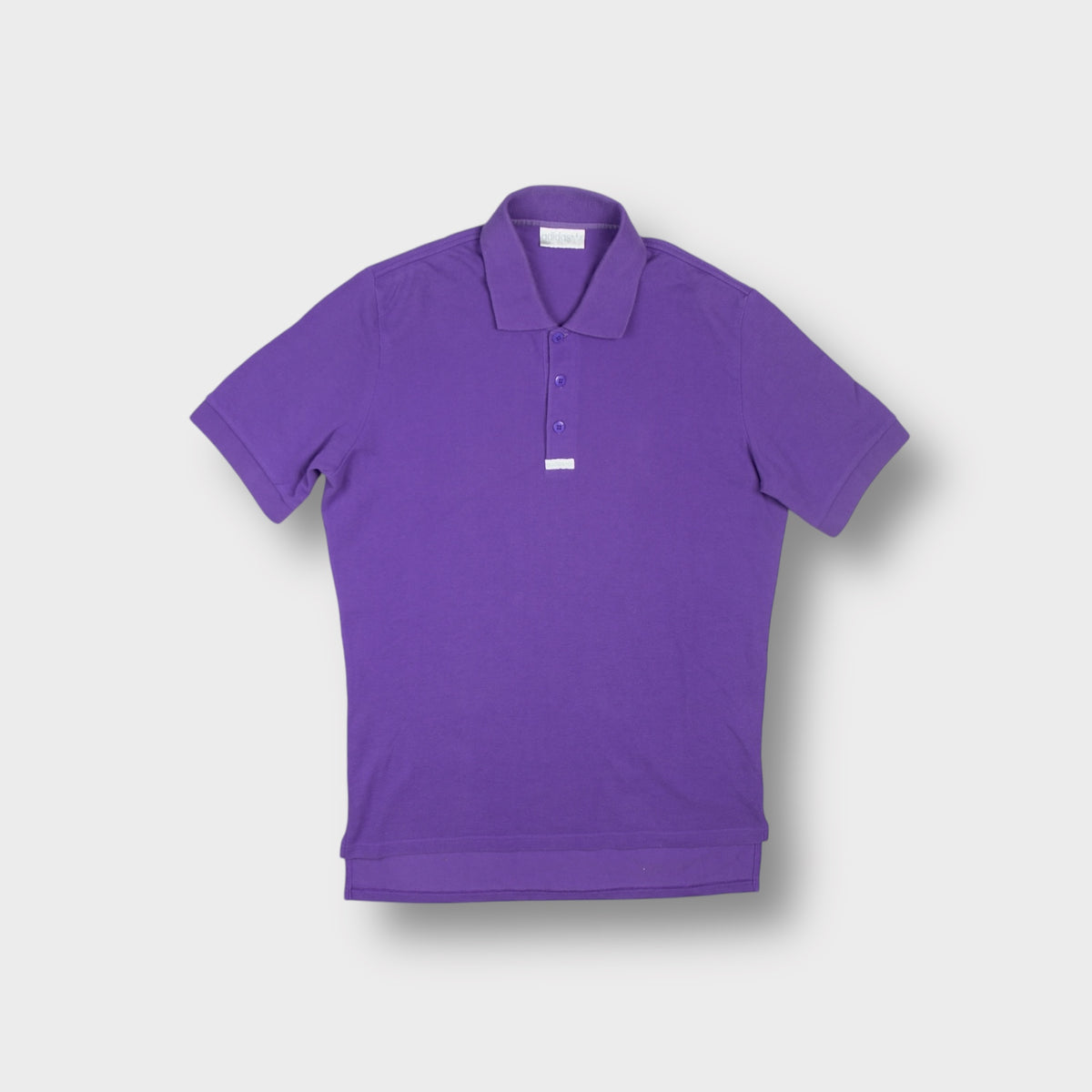 Purple Adidas polo shirt featuring a three-button placket and a small logo tab