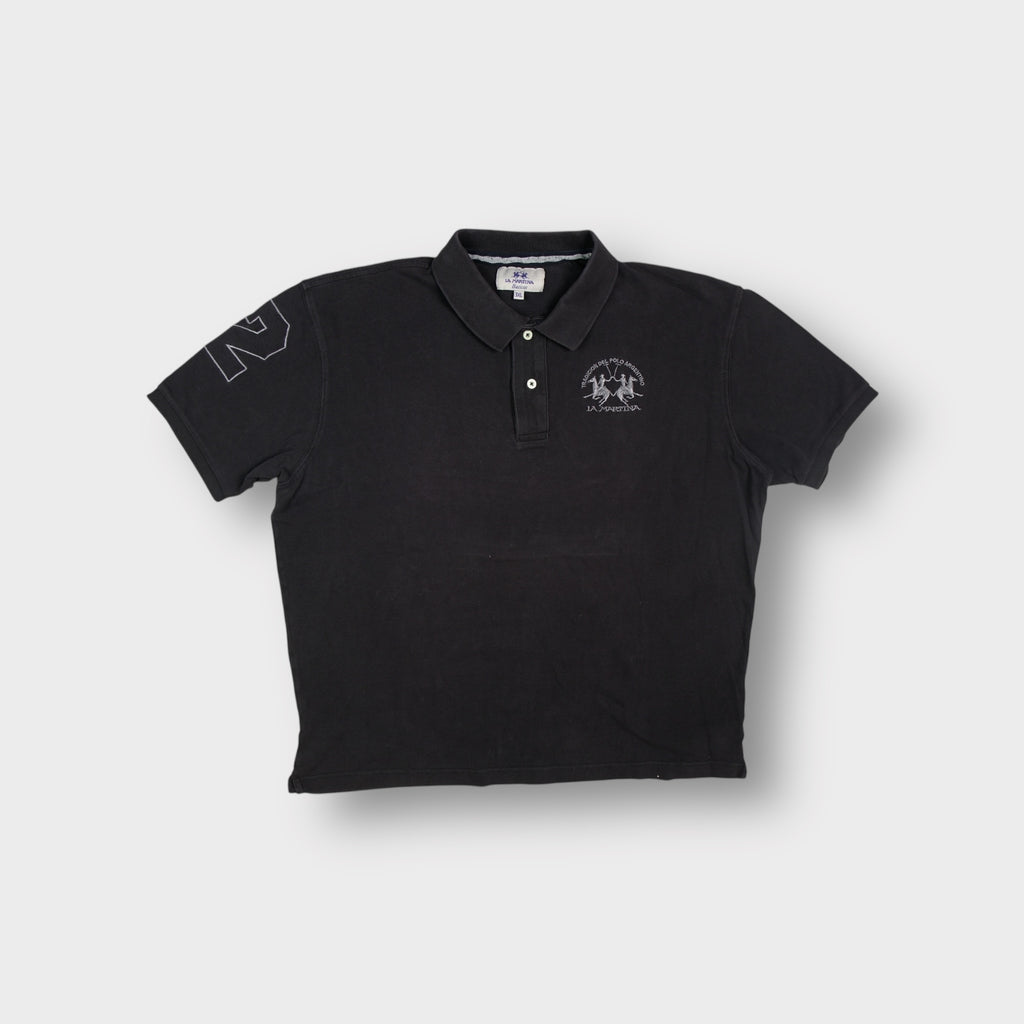 La Martina polo shirt in black featuring an embroidered Tradicion Del Polo Argentino chest logo