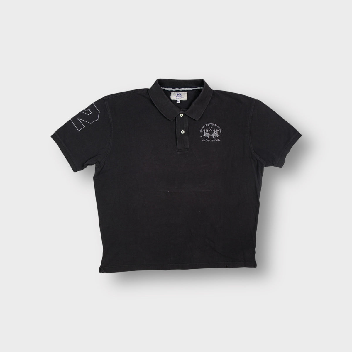 La Martina polo shirt in black featuring an embroidered Tradicion Del Polo Argentino chest logo