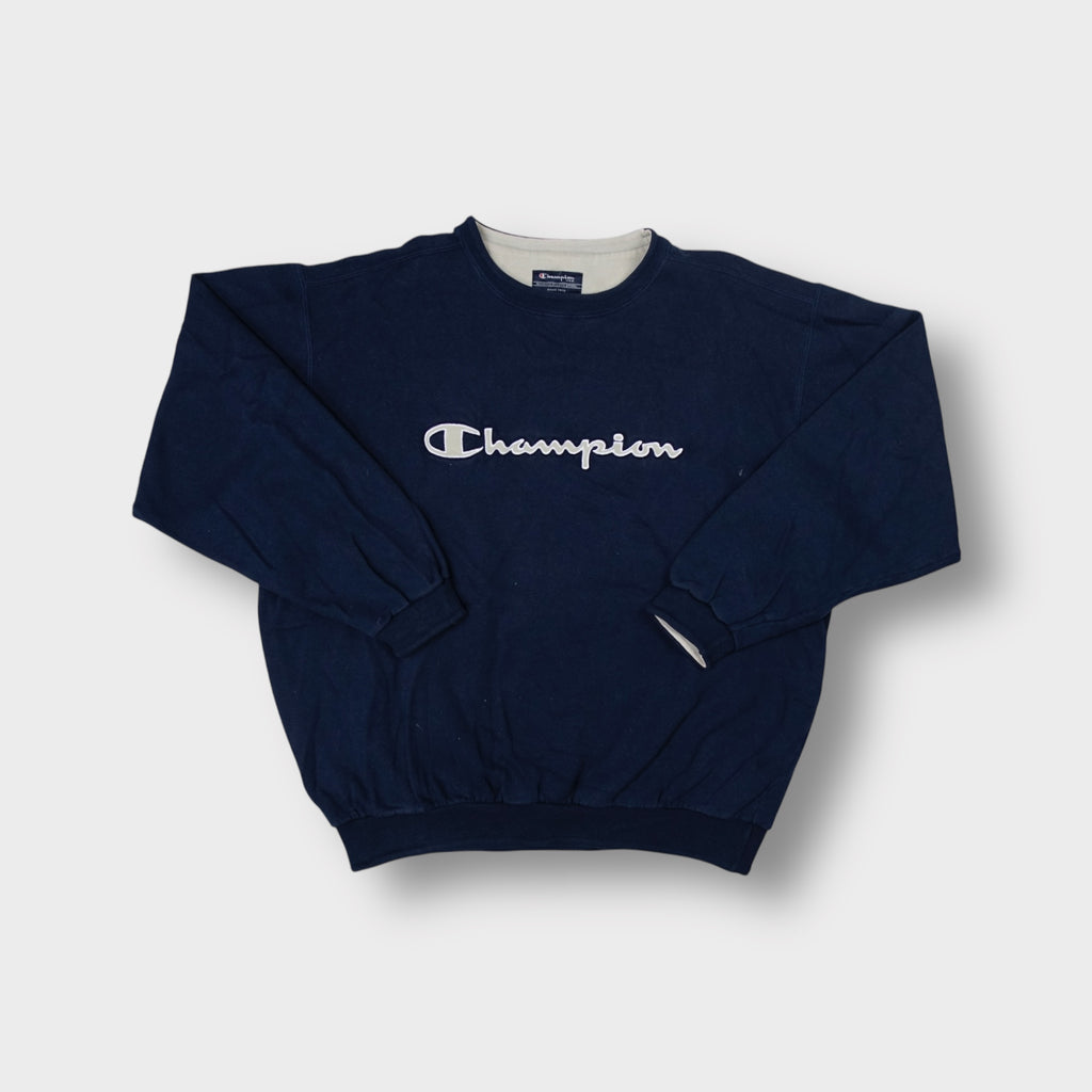 Navy blue Champion crewneck sweater with light grey embroidered script chest logo