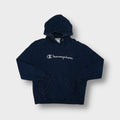 Champion hoodie in navy blue with grey cursive script logo applique on chest