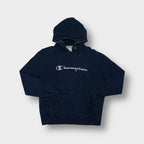 Champion hoodie in navy blue with grey cursive script logo applique on chest