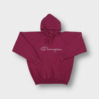 Red Champion hoodie featuring a white printed script logo on the chest
