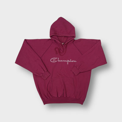 Red Champion hoodie featuring a white printed script logo on the chest