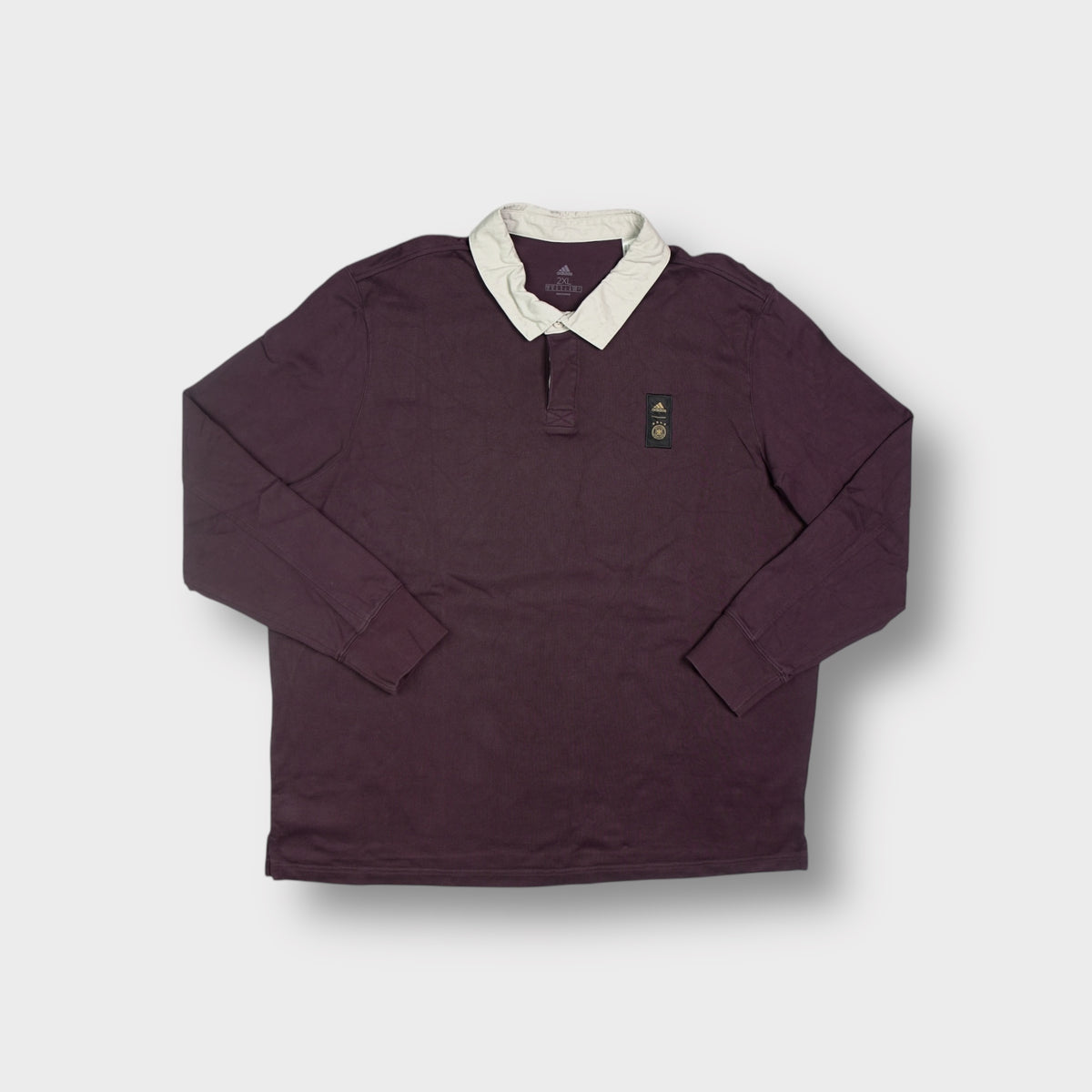Adidas DFB polo sweater in dark red featuring a white collar and embroidered chest patch
