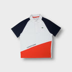 Lacoste Sport polo shirt in white with navy raglan sleeves and an orange diagonal lower panel