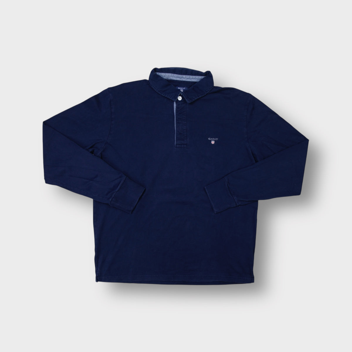 Gant long-sleeve polo sweater in navy blue with an embroidered shield logo on the chest