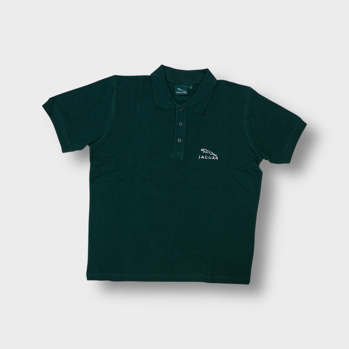 Jaguar dark green polo shirt featuring white embroidered emblem on left chest