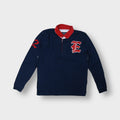 East West long-sleeve polo sweater in navy blue with red collar and crest patch