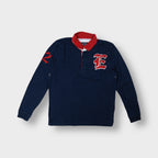 East West long-sleeve polo sweater in navy blue with red collar and crest patch