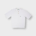Barbour short-sleeved white polo shirt with green embroidered logo on the chest pocket.