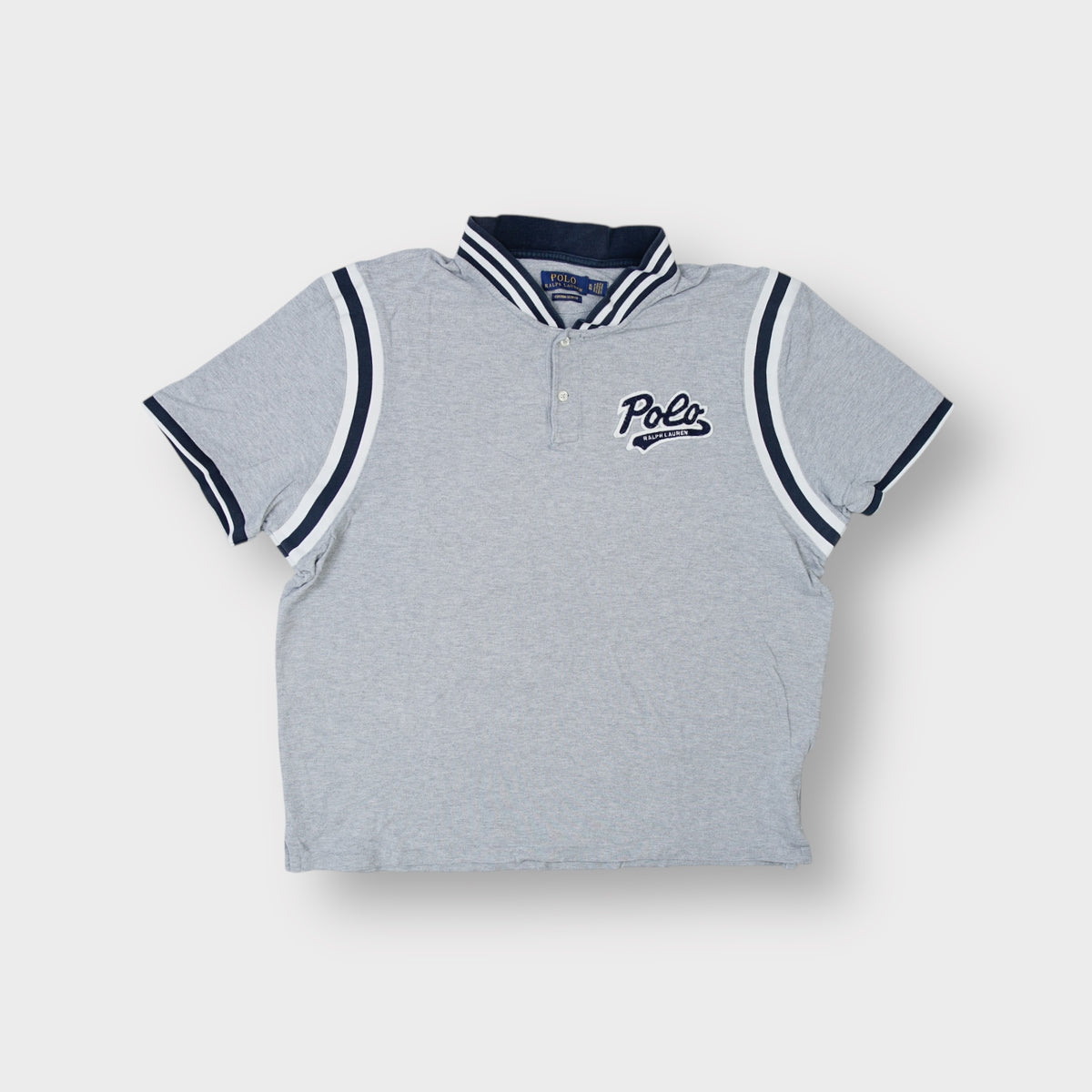 Ralph Lauren grey polo shirt featuring a navy script patch and striped collar trim