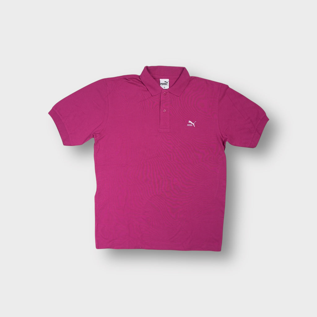 Puma short-sleeve polo shirt in pink featuring an embroidered white cat logo on chest.