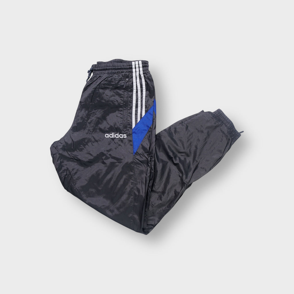 Adidas track pants in grey featuring white side stripes, blue panels and embroidered logo