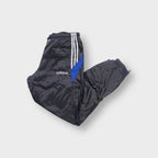 Adidas track pants in grey featuring white side stripes, blue panels and embroidered logo