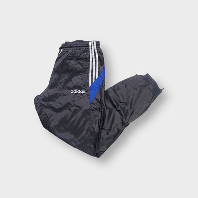 Adidas track pants in grey featuring white side stripes, blue panels and embroidered logo