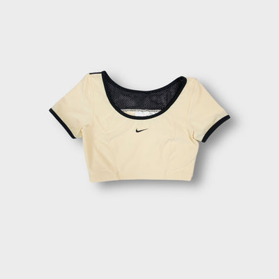 Nike crop top in light yellow featuring black trim details and small center swoosh logo