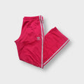 Adidas pink track pants with silver side stripes and white trefoil logo embroidery