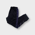 Reebok trackpants in black featuring side snap buttons and white embroidered logo