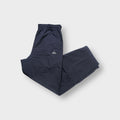 Adidas trackpants in grey with a small embroidered performance logo on the upper leg.
