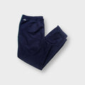 Lacoste trackpants in blue with green side piping and iconic embroidered crocodile logo.