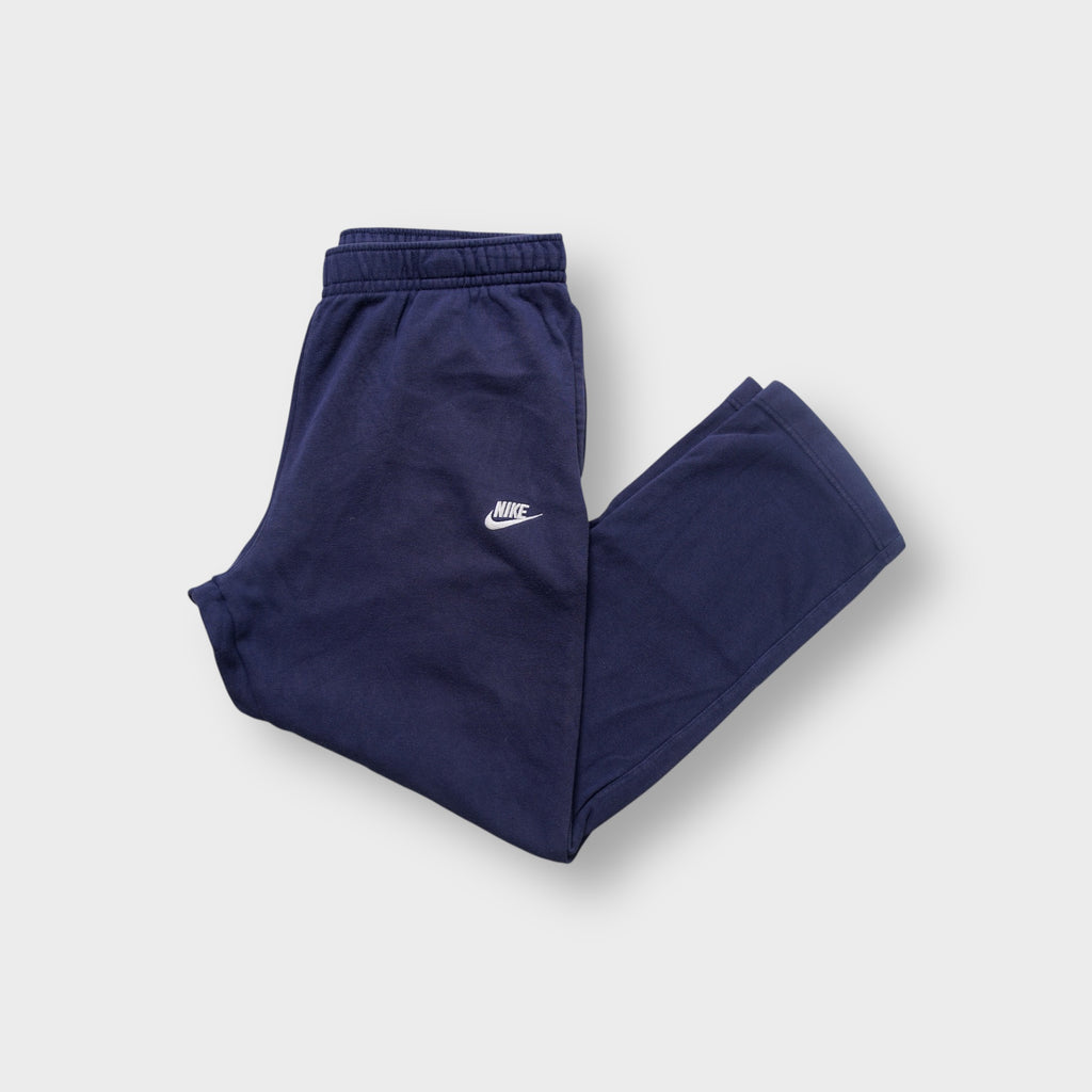 Nike navy blue track pants with an elastic waist and an embroidered white Futura logo