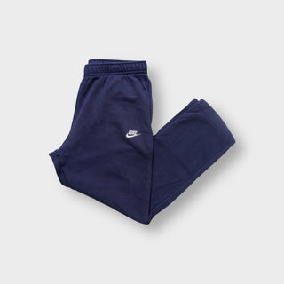 Nike navy blue track pants with an elastic waist and an embroidered white Futura logo